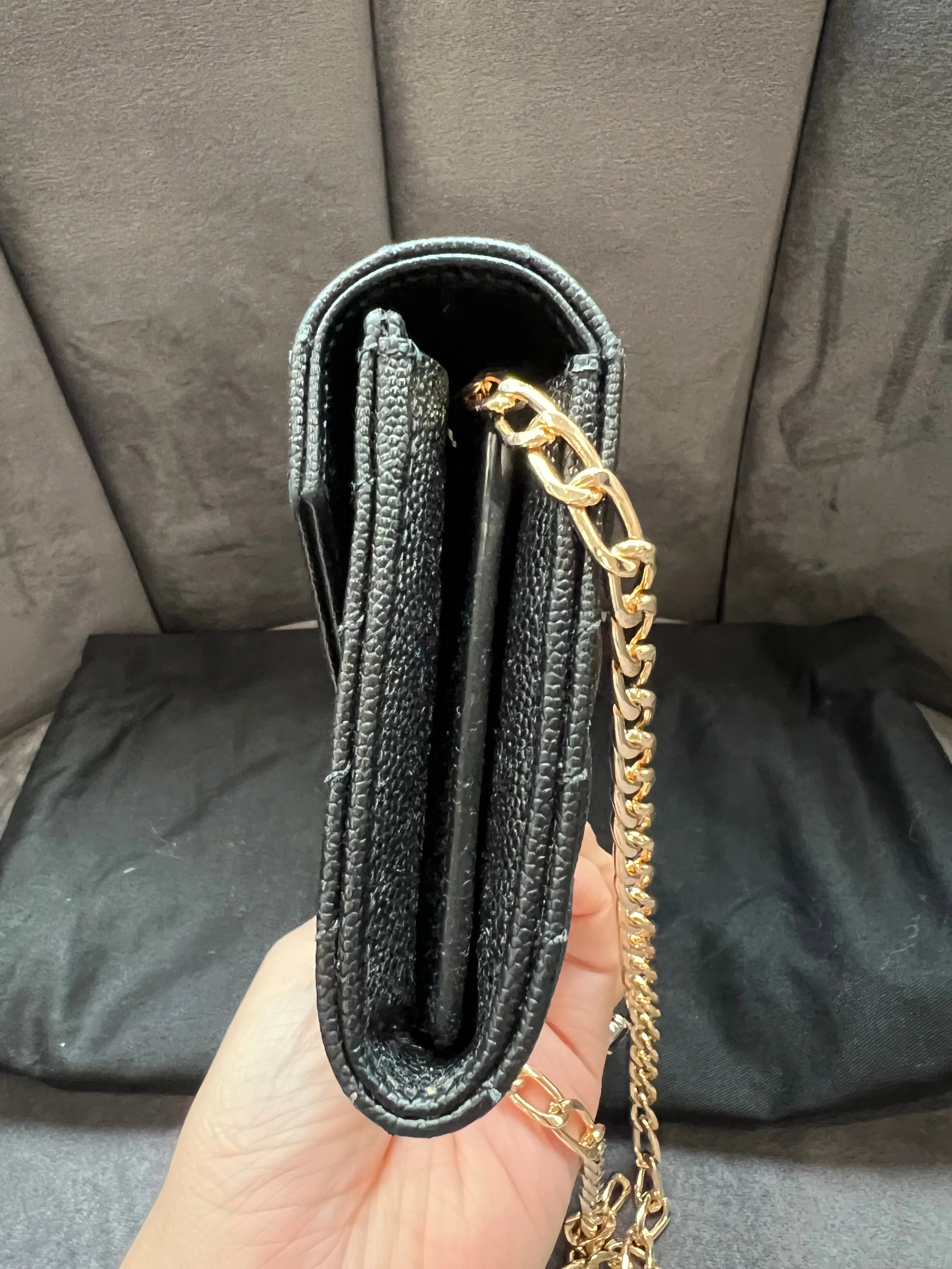 Black YSL cassandre wallet on chain