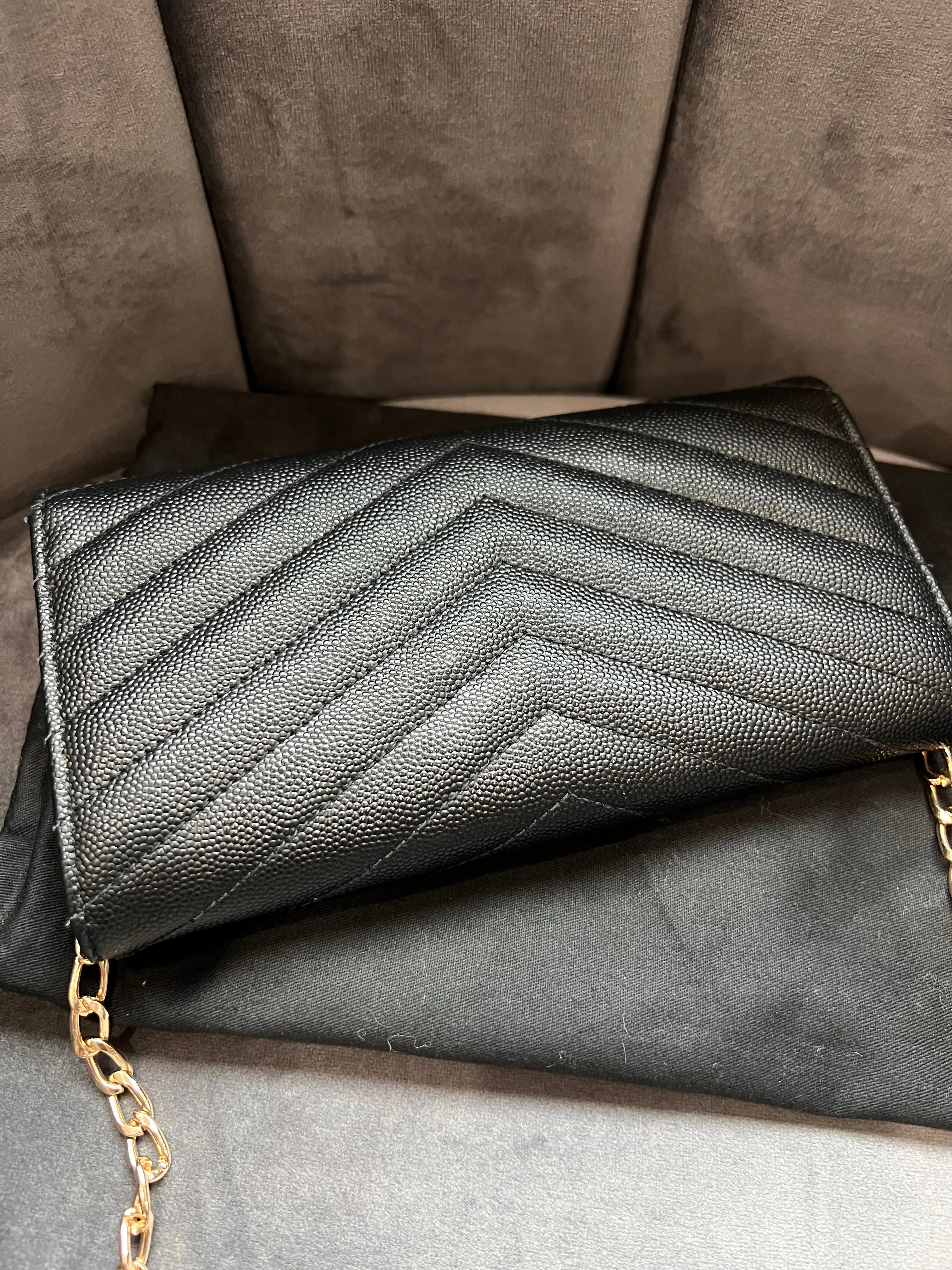 Black YSL cassandre wallet on chain