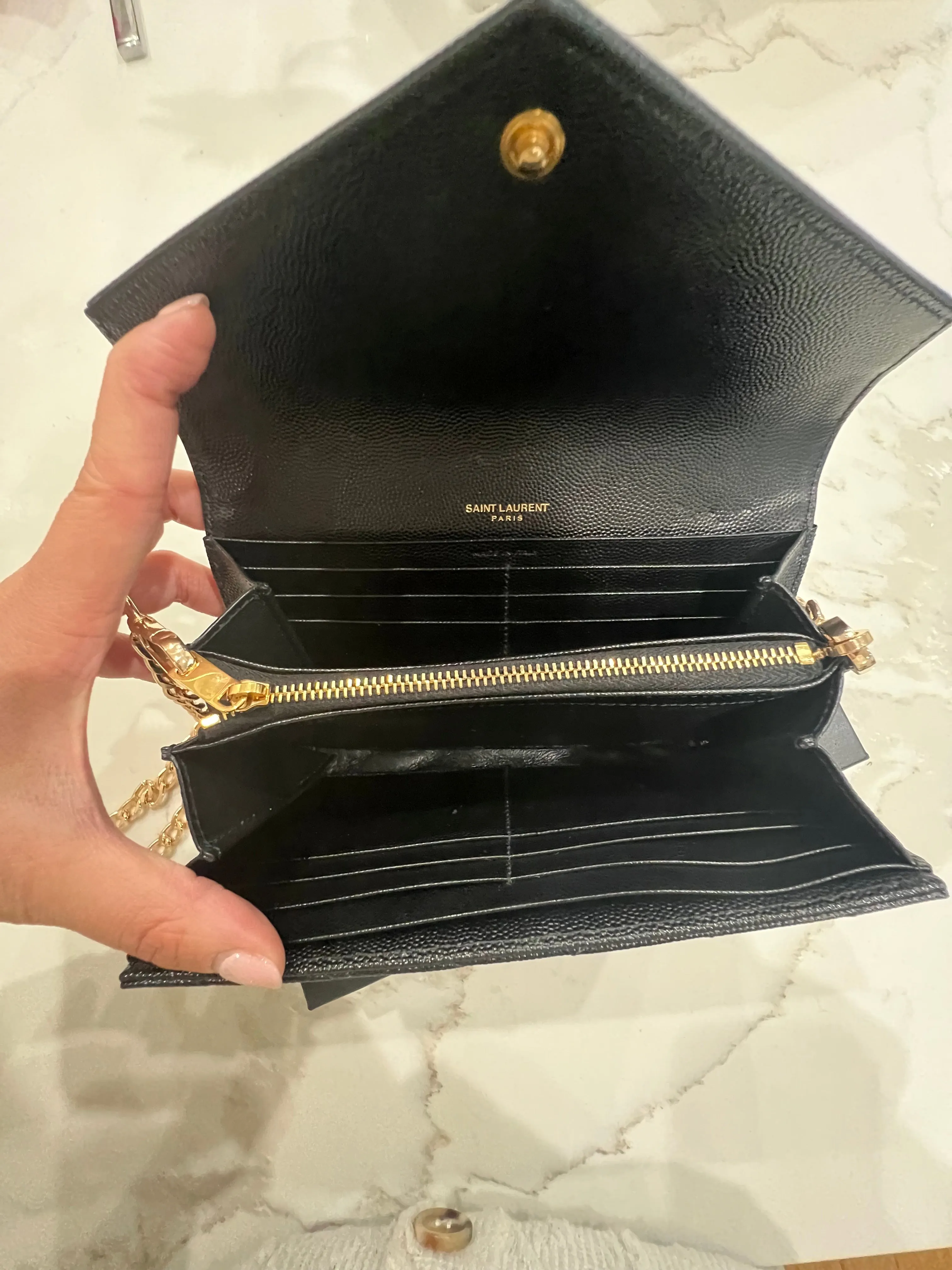 Black YSL cassandre wallet on chain