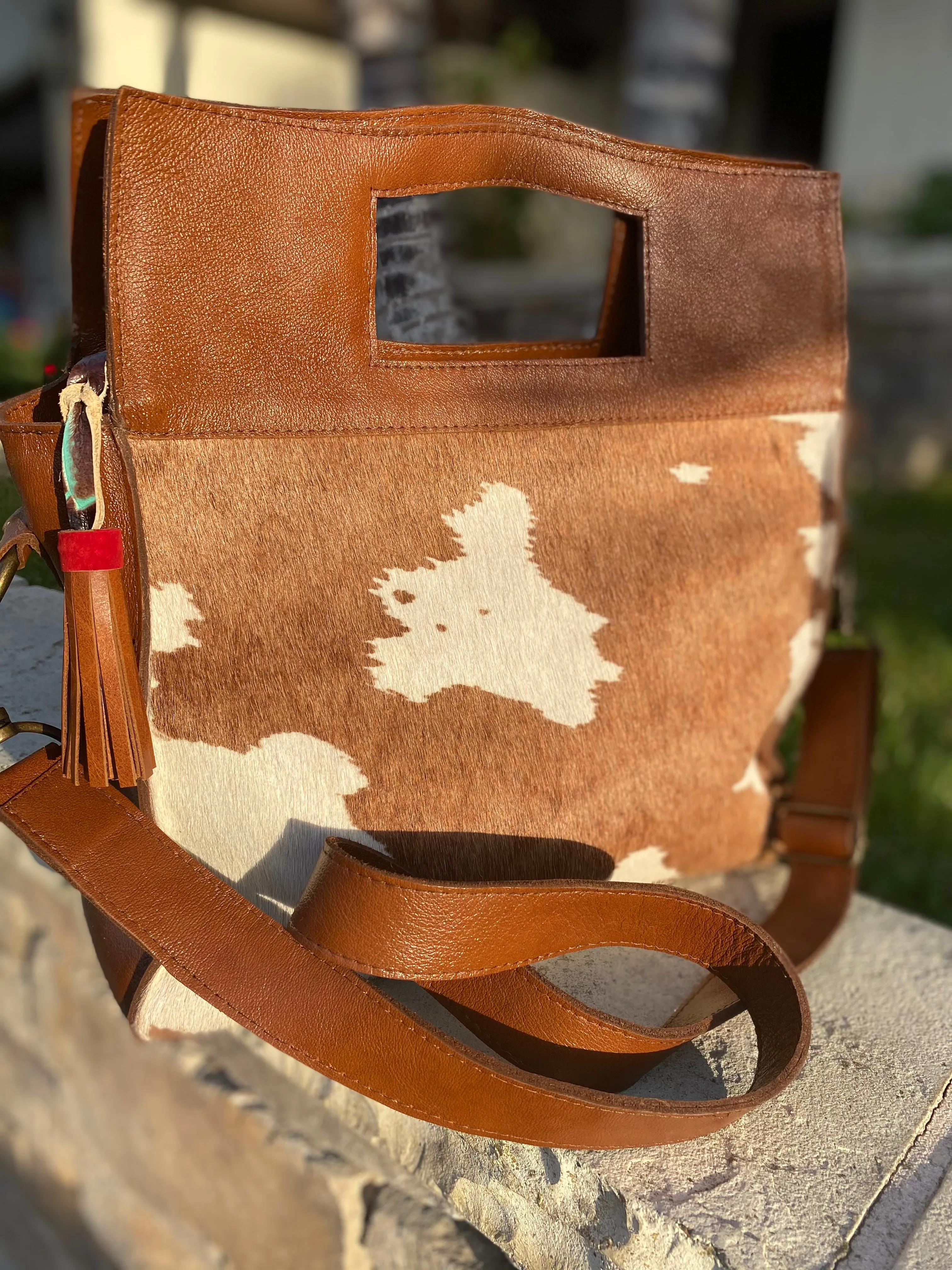 Large cowhide bucket style crossbody.